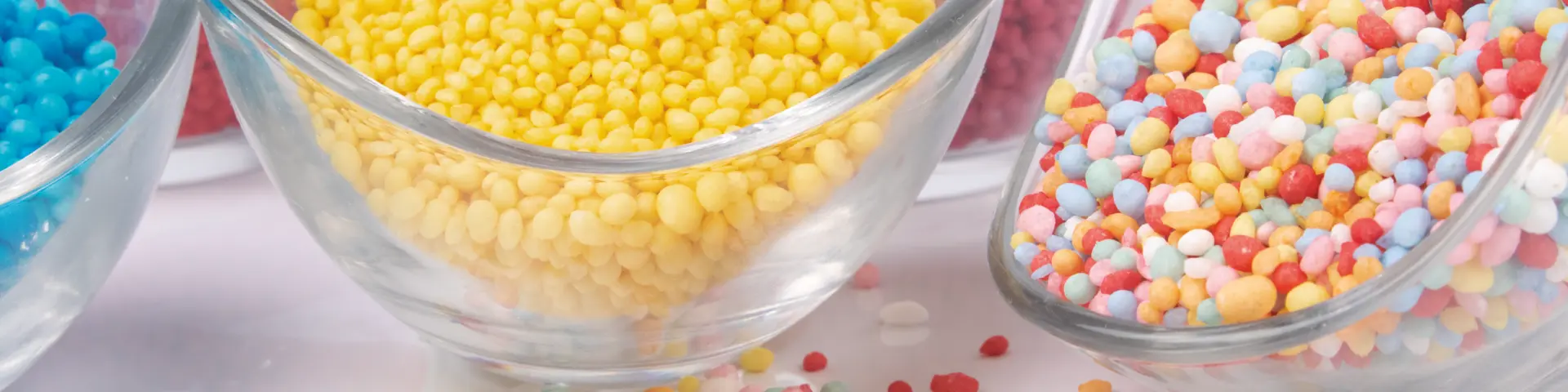Colourful sugar decorations in glass bowls