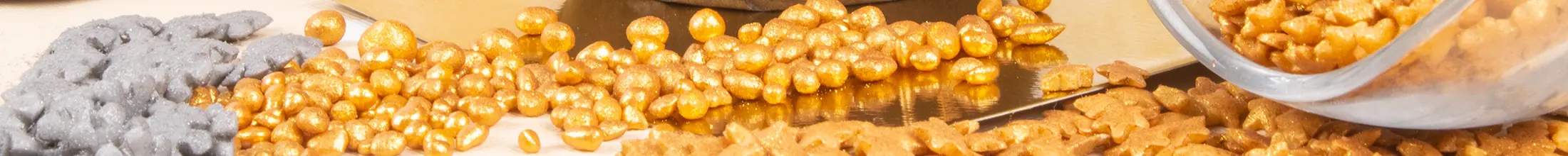 Gold and silver sugar decorations arranged across the banner