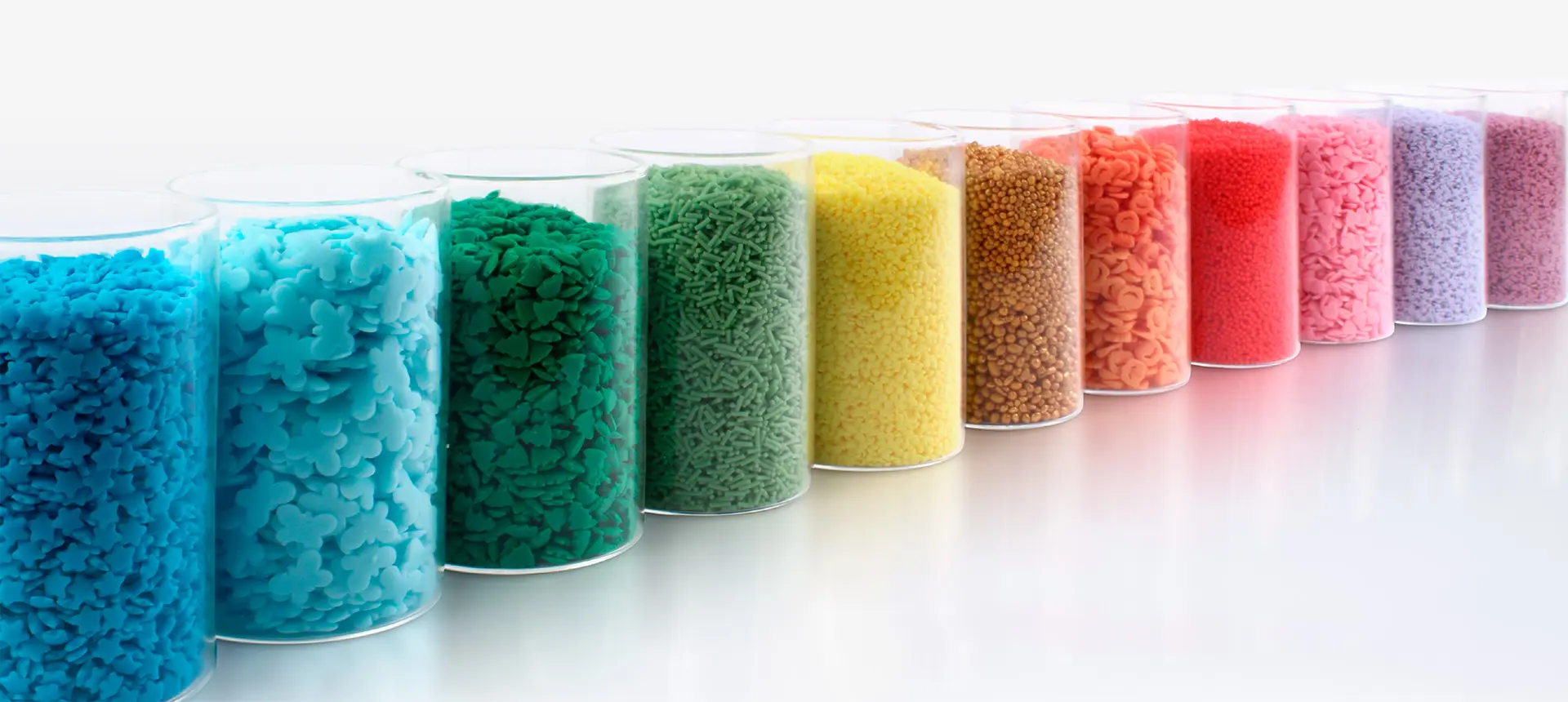 Colourful sugar decorations displayed by colour